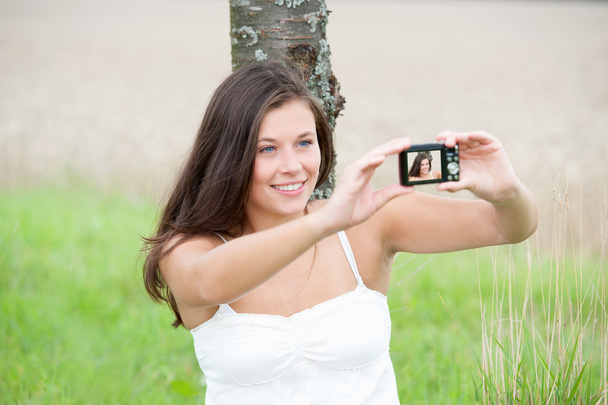 Όμορφη νεαρή γυναίκα που λαμβάνονται εικόνα του εαυτού της, selfie - Φωτογραφία, εικόνα