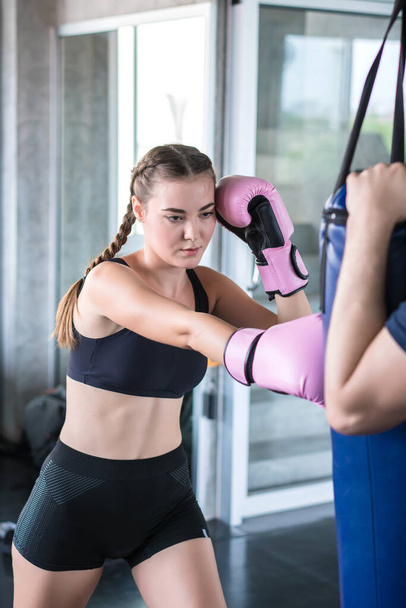 beautiful woman with boxing gloves exercise in fitness gym. - Foto, immagini