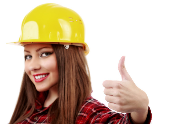 blurred face young engineer with helmet showing ok sign - Фото, изображение