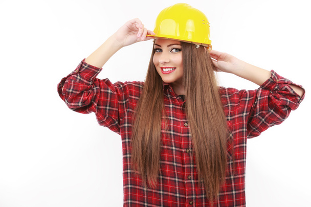 Young female architect or builder wearing a yellow hart hat on a - Photo, Image