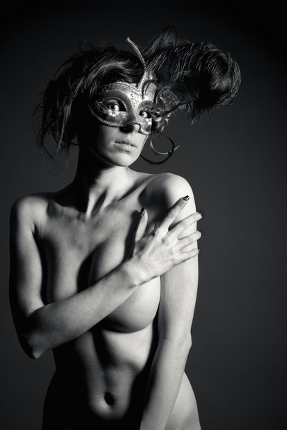 Attractive nude woman wearing a mysterious venetian mask   - Valokuva, kuva