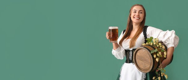 Beautiful Octoberfest waitress with beer on green background with space for text - Foto, Imagem