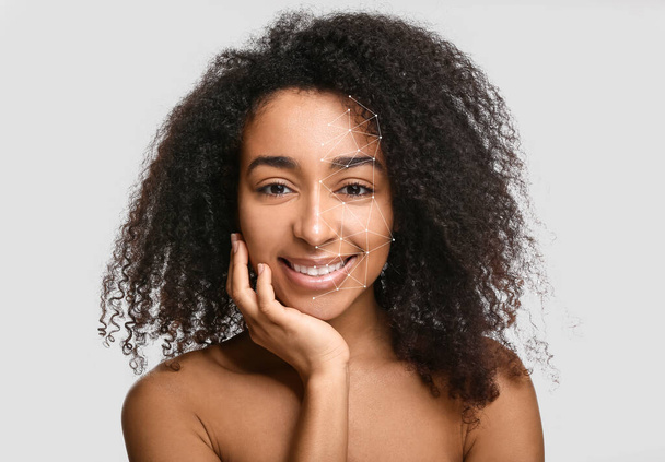 Young African-American woman with healthy skin on light background - Photo, image