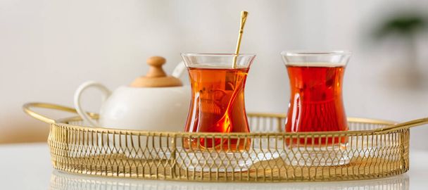 Tray with glass cups of aromatic Turkish tea on table - Photo, image