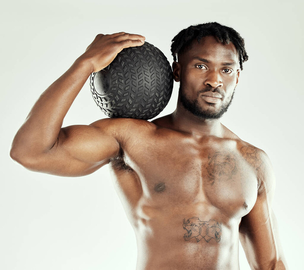 New year. New goals. Studio shot of an athletic young man posing with a medicine ball - Zdjęcie, obraz
