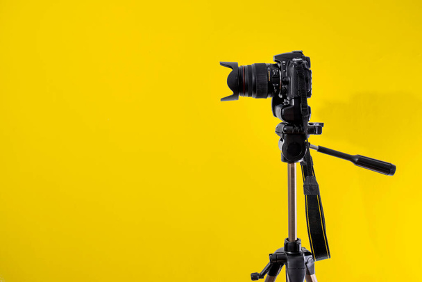 DSLR camera on yellow background - Foto, Imagem