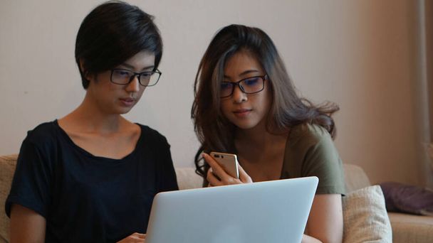 Two entrepreneur Asian woman glasses working from anywhere with laptop computer - Zdjęcie, obraz