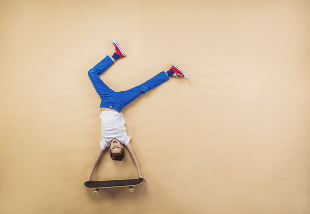 Boy is playing with skateboard - Φωτογραφία, εικόνα