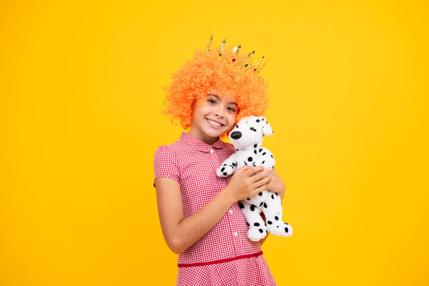 Girls party, funny kid in fancy clown wig in crown. Child queen wear diadem tiara. Cute little princess portrait - Photo, image