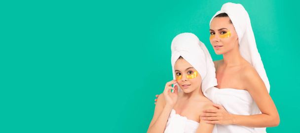 Mother and daughter child banner, copy space, isolated background. mother and teen girl reduce eye bag. facial collagen skincare cosmetic. moisturizing skin - Foto, imagen
