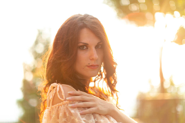 beautiful Italian girl with light dress at sunset. High quality photo - 写真・画像
