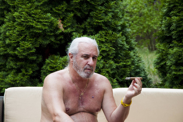 senior man with cigar. senior man enjoying cigar. senior smoker. - Zdjęcie, obraz
