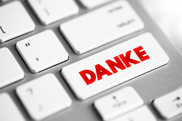 Danke (thank you in german) text button on keyboard, concept background - Photo, Image