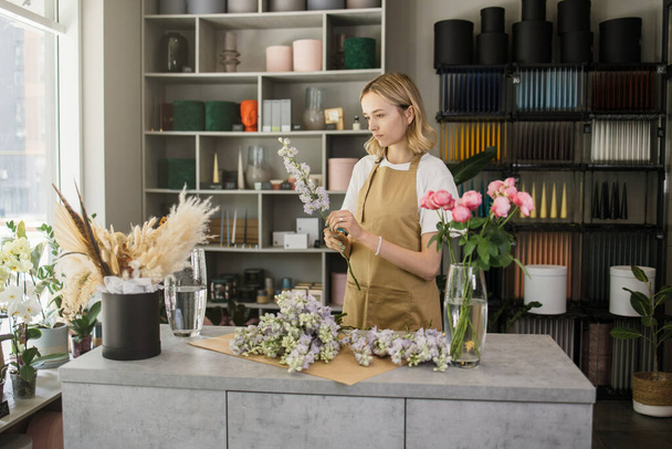 Small business. Female florist in flower shop. Floral design studio, making decorations and arrangements. Flowers delivery, creating order. - Fotoğraf, Görsel