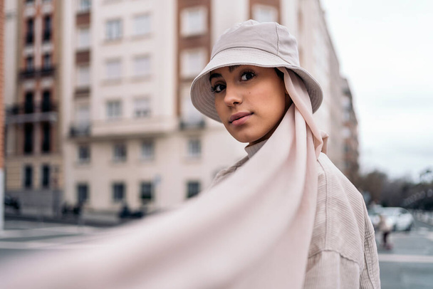 Beautiful muslim woman wearing head scarf posing and looking at camera in the street. - Photo, Image