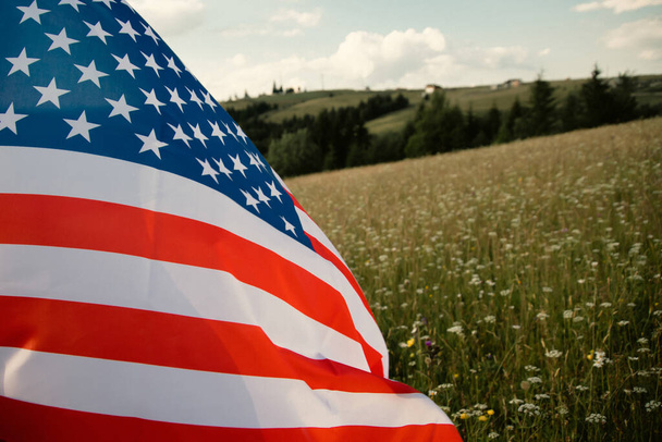 Close up view of USA flag against a summer meadow. 4th of July - Independence day. - Foto, Imagem