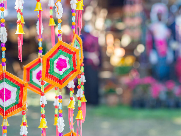 Crafting colorful yarn to use decorations for festivals. Decorative Mobile Spider web weaving hanging on a tree. Space for text. - 写真・画像