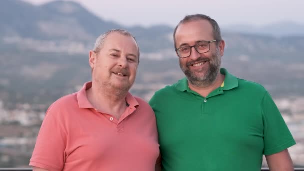 Happy middle aged male couple posing together outdoors. Love, relationship and LGBT concept. - Footage, Video