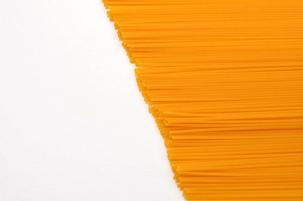 uncooked spaghetti on white background, copy space - Fotó, kép