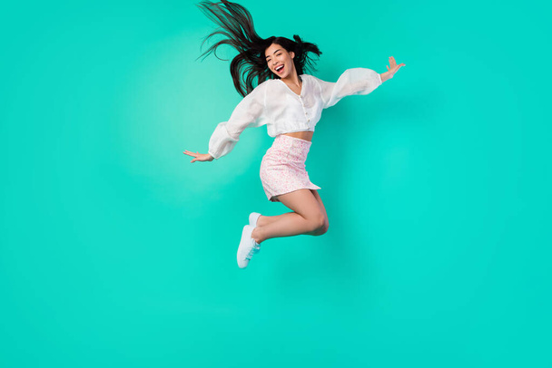 Full body photo of cheerful lady excited jump high active moving isolated cyan color background. - Foto, Imagen