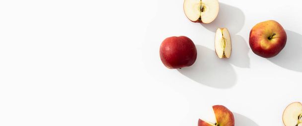 Whole, halves and cut apples on a white background. Top view, flat lay. Banner. - Photo, image