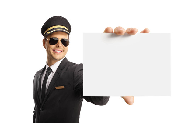 Professional chauffeur holding a blank card and smiling isolated on white background - Φωτογραφία, εικόνα