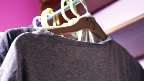 Clothes hung on a rail medium 4k shot slow motion selective focus - Video