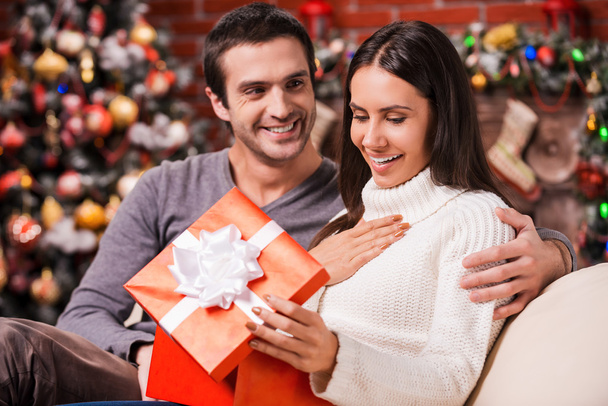 Woman opening a gift box on Christmas - 写真・画像
