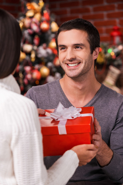 Man giving gift box to girlfriend on Christmas - 写真・画像