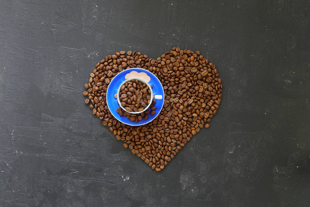Heart coffee. Roasted coffee beans in the shape of heart on bright stone background. Concept of coffee love, Valentines Day, good mood, gift. - Fotografie, Obrázek