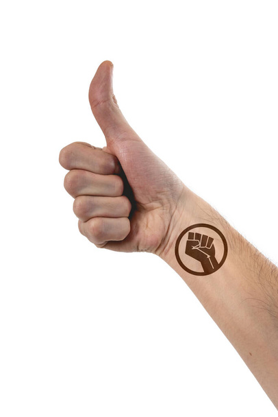 Beautiful and stylized hand of caucasian person thumbing up with a big tattoo of 'black live matters' over 100% white background - Fotoğraf, Görsel