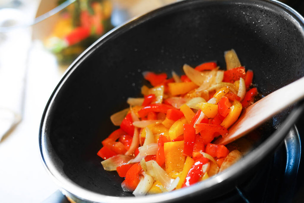 Cooking fresh vegetables in frying pan on stove, closeup - Foto, Imagem