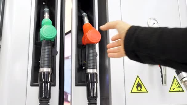 Close up of hand and fuel nozzle. Media. Fuel nozzle getting put into its place, fuel, gas station, petrol prices concept - Footage, Video