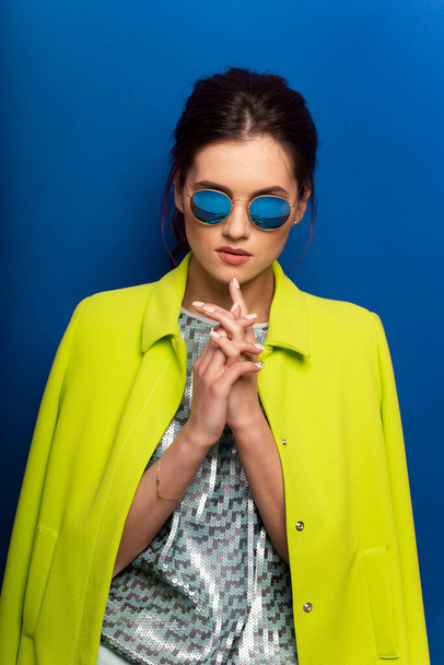 Beauty portrait of a fashion model in sunglasses, beautiful smiling young woman dressed in a trend clothes. - Foto, Imagem