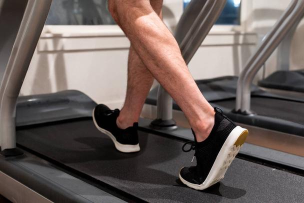 A man exercising while walking or running on a treadmill - Φωτογραφία, εικόνα
