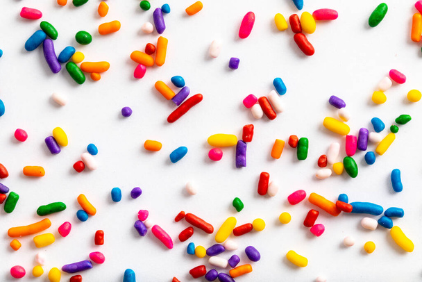 Rainbow sprinkles including yellow, orange, red, pink, purple, blue, green, and white - Fotografie, Obrázek