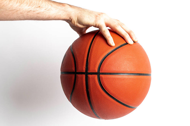 Male holding a basketball in his hand on a white background - Photo, image