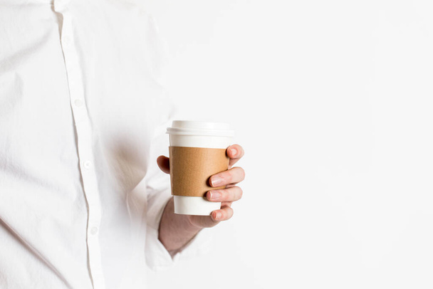 Coffee cup to go being held out by a barista, waiter, or professional - Fotó, kép
