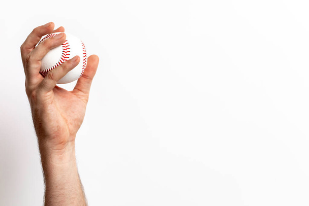 A baseball being tossed from a hand on a white background - Fotoğraf, Görsel
