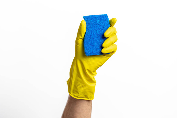 Blue cleaning sponge in a hand against a white background - Foto, imagen