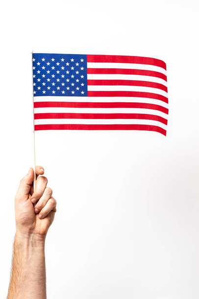 Person holding the american flag representing the usa - Foto, afbeelding