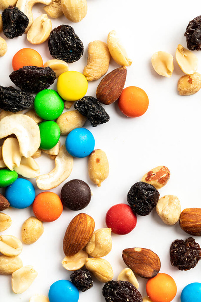 Trail mix including peanuts, almonds, cashews, raisins, and chocolate - Photo, image