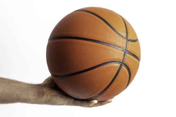 Male holding a basketball in his hand on a white background - Foto, Imagem