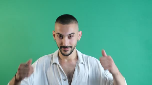 Man doing like sign, young man making a like sign with both hands, show body language and facial expressions in front of a green screen - Filmati, video