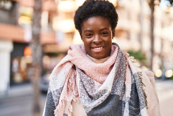 African american woman smiling confident standing at street - Foto, Bild