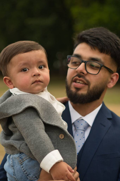 Asian Pakistani Father is holding his 11 Months Old Infant at Local Park of London Luton England UK - Fotografie, Obrázek