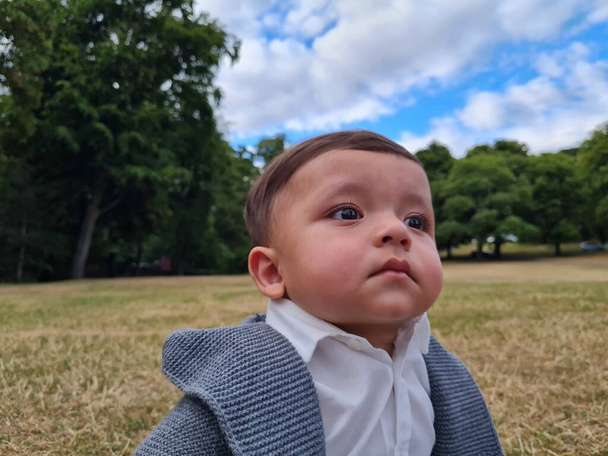 11 Months old Cute Baby is Enjoying and Posing to Camera at Park of Luton England UK - Φωτογραφία, εικόνα