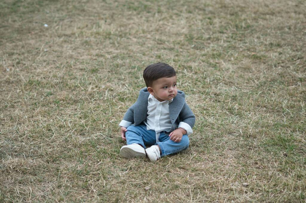 11 Months old Cute Baby is Enjoying and Posing to Camera at Park of Luton England UK - Valokuva, kuva