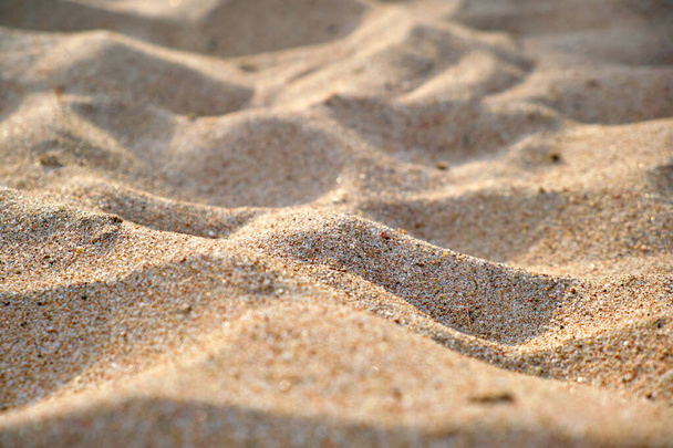 Close up of clean yellow sand surface covering seaside beach illuminated with day light. Travel and vacations concept. - Fotografie, Obrázek