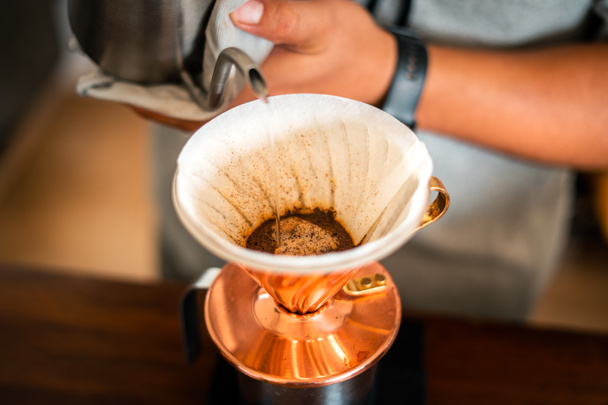 Drip coffee, barista pouring water on coffee ground with filter,Close up of hand brewing coffee  - Foto, Imagen